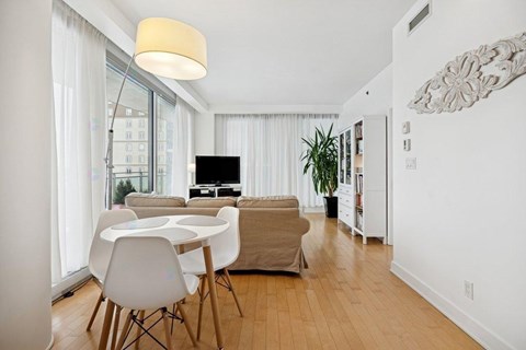 A modern living room with a white table and chairs.