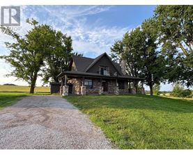 A house with a gravel driveway in front of it.