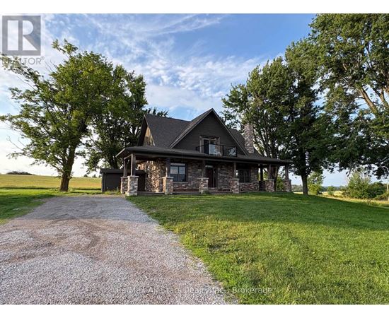A house with a gravel driveway in front of it.