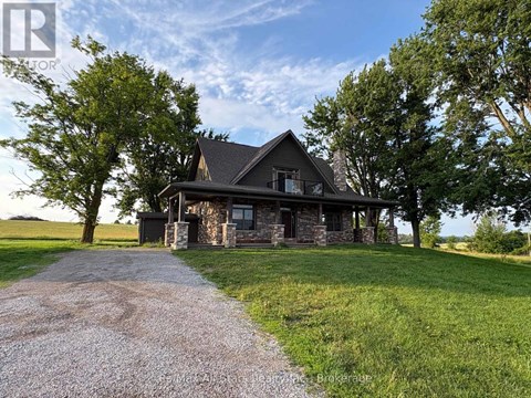 A house with a gravel driveway in front of it.