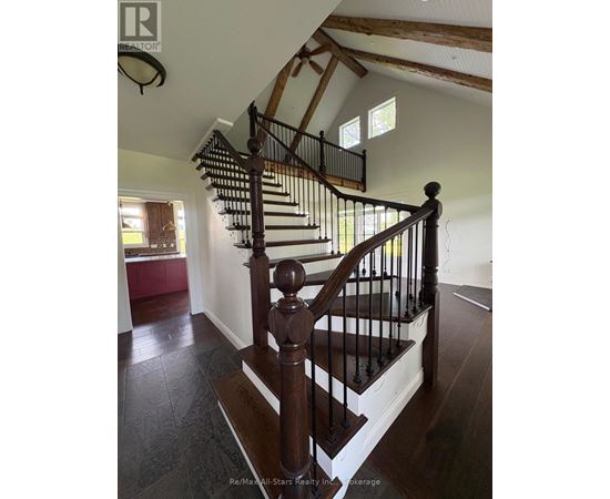 A wooden staircase with a metal railing.