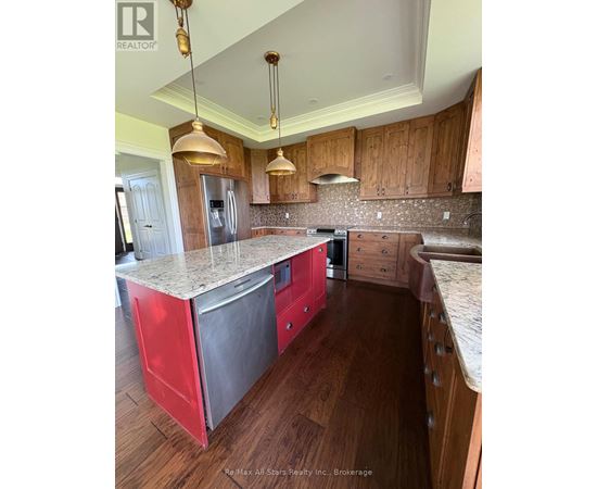 A kitchen with wooden cabinets and a granite countertop.