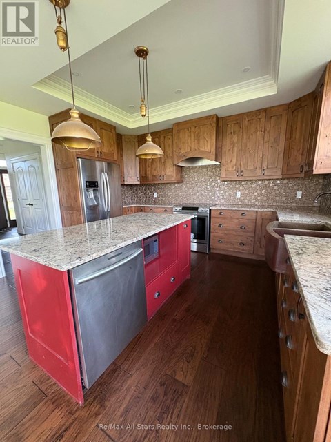A kitchen with wooden cabinets and a granite countertop.