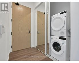 A laundry room with a washer and dryer stacked on top of each other.