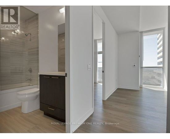 A bathroom with a toilet, sink, and a shower with a glass door.