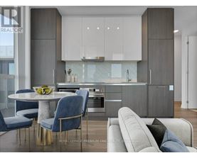 A modern kitchen with a dining table and chairs.