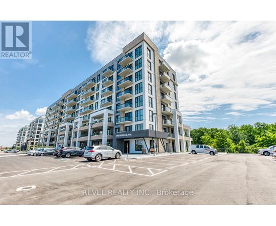 A multi-story building with a parking lot in front of it.