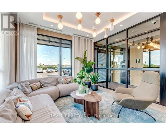 A living room with a large sectional sofa, a coffee table, and a view of the outdoors through large windows.