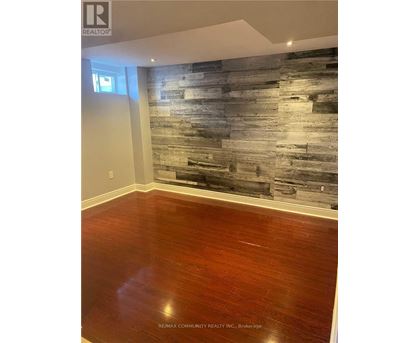 A room with a wooden floor and a wooden wall.