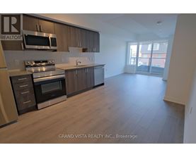 A kitchen with wooden cabinets and stainless steel appliances.