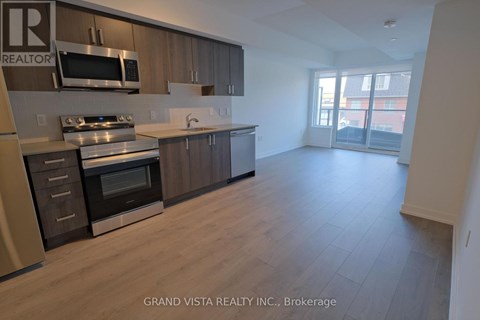 A kitchen with wooden cabinets and stainless steel appliances.