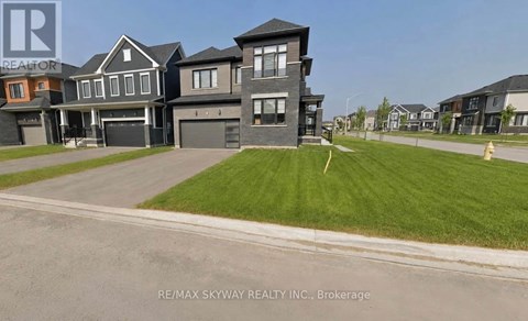 A large, modern house with a garage is for sale.