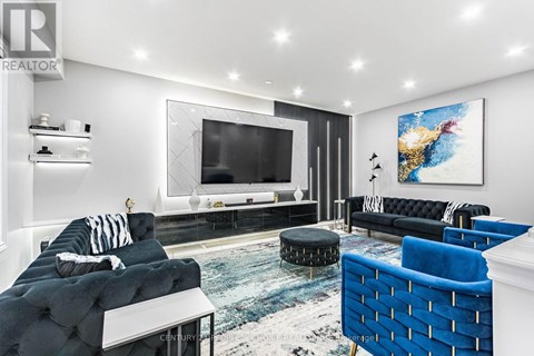 A living room with a black couch and a blue chair.