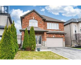 A house with a red brick exterior and a white garage door.