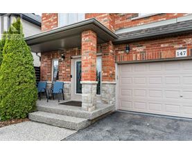 A house numbered 147 with a white garage door.