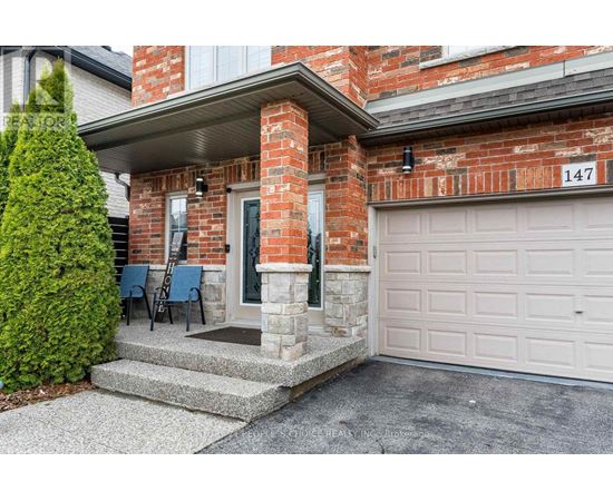 A house numbered 147 with a white garage door.