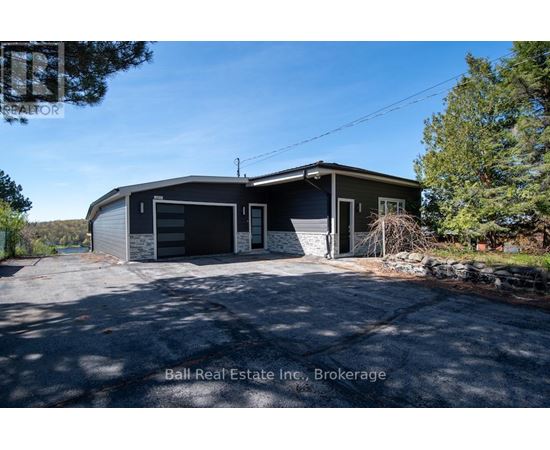 A two-story house with a garage is for sale.