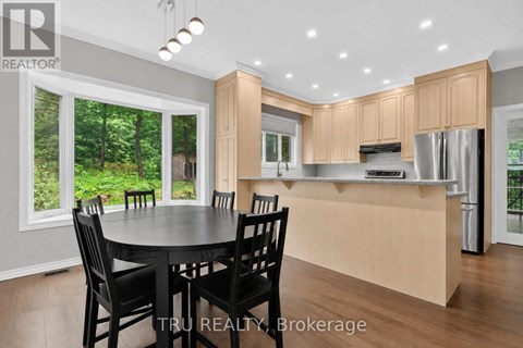 A modern kitchen with a dining table and chairs.
