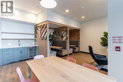 A conference room with a wooden table and chairs.