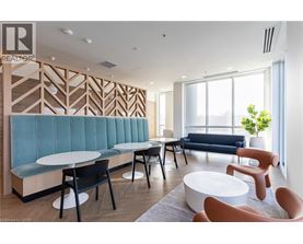 A modern living room with a blue sofa and wooden accents.