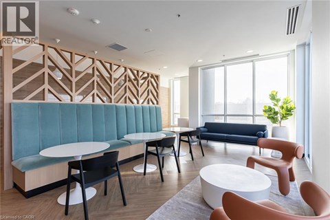 A modern living room with a blue sofa and wooden accents.