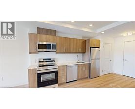 A kitchen with wooden cabinets and stainless steel appliances.
