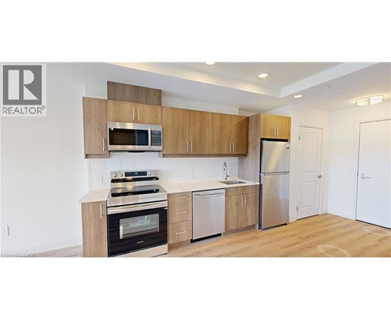 A kitchen with wooden cabinets and stainless steel appliances.