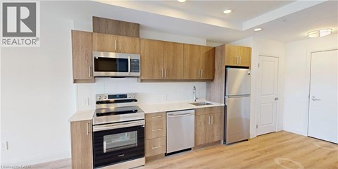 A kitchen with wooden cabinets and stainless steel appliances.