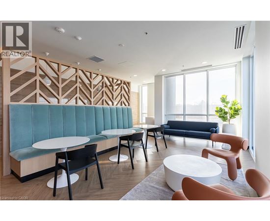 A modern waiting room with a blue sofa and wooden wall paneling.