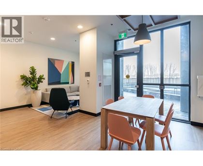 A modern dining room with a wooden table and chairs.