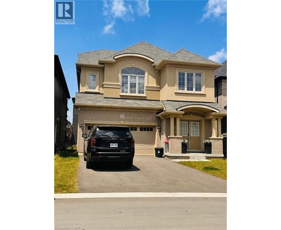 A house with a black SUV parked in front.