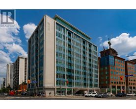 A large building with a glass facade is the focal point of the image.
