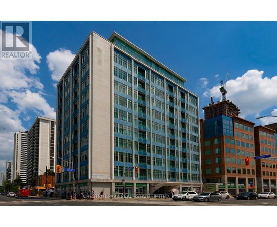 A large building with a glass facade is the focal point of the image.
