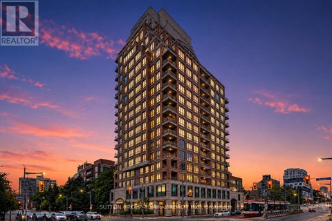 A tall building with many windows is the main focus of the image.