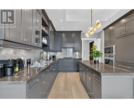 A modern kitchen with dark grey cabinets and a central island.
