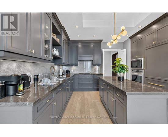 A modern kitchen with dark grey cabinets and a central island.