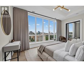 A bedroom with a large bed and a view of the city.