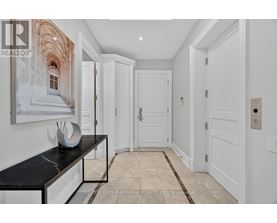 A hallway with white doors and a marble bench.