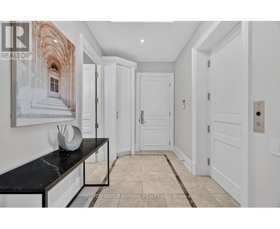 A hallway with white doors and a marble bench.