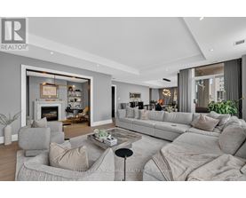A modern living room with a grey sofa set and a fireplace.