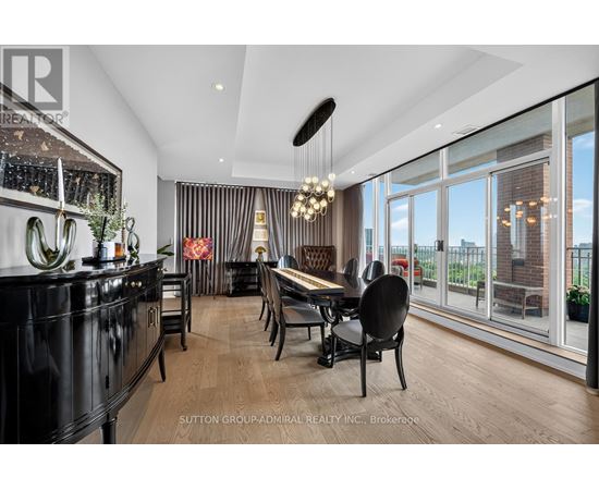 A modern dining room with a black cabinet and wooden chairs.