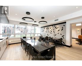 A modern dining room with a large table and chairs.