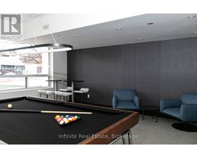 A pool table with a yellow ball and a cue stick on it.