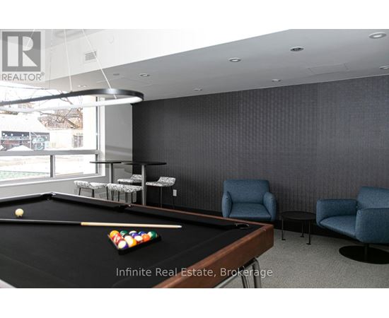 A pool table with a yellow ball and a cue stick on it.