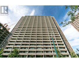 A tall residential building with a crane in the background.