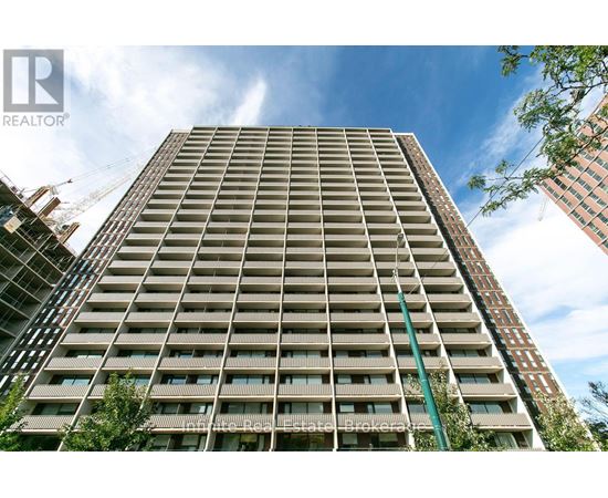 A tall residential building with a crane in the background.