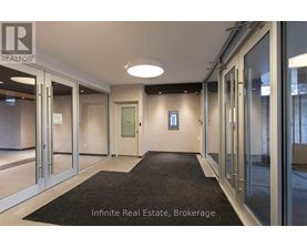 A hallway with a sign that says Infinite Real Estate Brokerage.