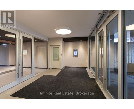 A hallway with a sign that says Infinite Real Estate Brokerage.