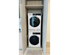 A white washing machine and dryer in a cabinet.