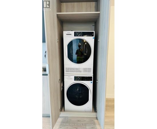 A white washing machine and dryer in a cabinet.